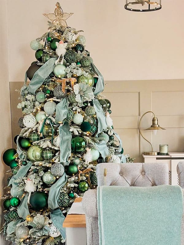 green christmas tree with white decorations